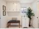 Functional laundry room is equipped with cabinets, sink and window at 6585 E Nevada Pl, Denver, CO 80224