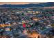 Aerial view of a residential neighborhood at dusk, highlighting the density and layout of the community at 12028 W Aqueduct Dr, Littleton, CO 80127