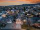 Aerial view of a residential area with well-maintained homes, and a mountain backdrop, showcasing a peaceful neighborhood at 12028 W Aqueduct Dr, Littleton, CO 80127