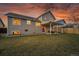 Lovely backyard with a covered patio, lush lawn, mature tree, and well-manicured landscaping, great for entertaining at 12028 W Aqueduct Dr, Littleton, CO 80127