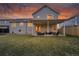 Spacious backyard featuring a covered patio, lush lawn, and well-maintained landscaping, ideal for outdoor enjoyment at 12028 W Aqueduct Dr, Littleton, CO 80127