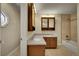 Bathroom featuring dual sinks, vanity with storage, and a tiled shower and bathtub combination at 12028 W Aqueduct Dr, Littleton, CO 80127