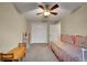 Cozy bedroom offers a ceiling fan and a pleasant setup, perfect for relaxation and creative activities at 12028 W Aqueduct Dr, Littleton, CO 80127