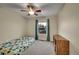 Inviting bedroom with a ceiling fan and natural light from the window offering serene views at 12028 W Aqueduct Dr, Littleton, CO 80127
