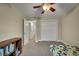 Comfortable bedroom with ample closet space, ceiling fan, and neutral tones creating a cozy atmosphere at 12028 W Aqueduct Dr, Littleton, CO 80127