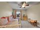 Light-filled bedroom boasts a ceiling fan and a cozy setup for relaxation and play at 12028 W Aqueduct Dr, Littleton, CO 80127