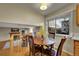Cozy breakfast nook with wooden table and chairs next to a bright window and overlooking the living room at 12028 W Aqueduct Dr, Littleton, CO 80127