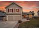 Inviting home with a two-car garage, complemented by a cozy front porch and landscaped front yard at 12028 W Aqueduct Dr, Littleton, CO 80127