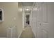 Bright hallway features neutral tones, plush carpet, and ample closet space for convenient storage at 12028 W Aqueduct Dr, Littleton, CO 80127