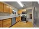 Modern kitchen featuring stainless steel appliances, stylish countertops, and ample cabinet space, perfect for cooking enthusiasts at 12028 W Aqueduct Dr, Littleton, CO 80127