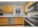 Bright kitchen with stainless steel appliances, solid countertops and wood cabinets offering lots of counter space at 12028 W Aqueduct Dr, Littleton, CO 80127