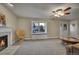 Bright living room boasts a window seat, decorative fireplace, neutral colors, and a cozy seating area at 12028 W Aqueduct Dr, Littleton, CO 80127