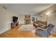 Comfortable living room featuring a fireplace, plush seating, and hardwood floors with an area rug at 12028 W Aqueduct Dr, Littleton, CO 80127