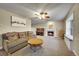 Cozy living room featuring a fireplace, comfortable seating, and a grand piano, perfect for relaxing and entertaining at 12028 W Aqueduct Dr, Littleton, CO 80127