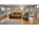Inviting living room with ample natural light, cozy furniture, and hardwood floors with a patterned rug at 12028 W Aqueduct Dr, Littleton, CO 80127