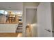 Open staircase leading to a lower level, with glimpses of the dining area and kitchen above at 12028 W Aqueduct Dr, Littleton, CO 80127