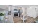 Bright kitchen featuring stainless steel appliances, gray cabinetry and wood-style flooring, perfect for modern living at 13563 E 103Rd Pl, Commerce City, CO 80022