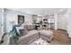 Bright living area seamlessly connected to the kitchen with stainless steel appliances at 13563 E 103Rd Pl, Commerce City, CO 80022