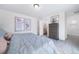 Bedroom featuring a dresser and doorway leading to the ensuite bathroom, promoting a relaxing space at 13563 E 103Rd Pl, Commerce City, CO 80022