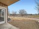 Backyard with gravel patio, view of golf course, and partial fence at 2833 W 119Th Ave # 15-102, Denver, CO 80234
