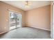Bright bedroom with sliding door to patio and ceiling fan at 2833 W 119Th Ave # 15-102, Denver, CO 80234