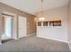 Open dining area with light fixture and kitchen access at 2833 W 119Th Ave # 15-102, Denver, CO 80234