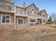 Tan 2 story townhome with stone accents and a balcony at 2833 W 119Th Ave # 15-102, Denver, CO 80234