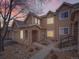 Townhouse exterior, stone and tan siding, walkway, and attached garage at 2833 W 119Th Ave # 15-102, Denver, CO 80234