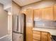 Kitchen features stainless steel refrigerator and light wood cabinets at 2833 W 119Th Ave # 15-102, Denver, CO 80234