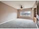 Spacious living room with fireplace, built-in shelving, and large window at 2833 W 119Th Ave # 15-102, Denver, CO 80234