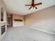 Spacious living room with fireplace, built-in shelving, and kitchen view at 2833 W 119Th Ave # 15-102, Denver, CO 80234
