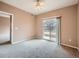 Main bedroom features neutral walls, carpeting, and a sliding glass door to a small balcony at 2833 W 119Th Ave # 15-102, Denver, CO 80234