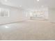 Large basement featuring neutral carpet, bright recessed lighting, and a bar area with cabinetry at 4066 N Irvington St, Aurora, CO 80019