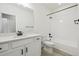 Modern bathroom featuring sleek fixtures, a bathtub with shower, and updated vanity at 4066 N Irvington St, Aurora, CO 80019