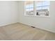Bedroom featuring neutral carpet, white walls, and a double window with views of neighboring homes at 4066 N Irvington St, Aurora, CO 80019