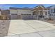 Long concrete driveway leading to a two-car garage at 4066 N Irvington St, Aurora, CO 80019