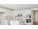 Modern kitchen with white cabinets, stainless steel appliances, and a center island at 4066 N Irvington St, Aurora, CO 80019
