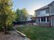 Serene backyard with pergola-covered patio, lush lawn, and mature landscaping at 518 Zircon Way, Superior, CO 80027