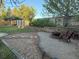 Landscaped backyard features a stone patio with a fire pit and seating area at 518 Zircon Way, Superior, CO 80027