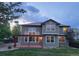 Back exterior with manicured yard and deck featuring outdoor string lights at 518 Zircon Way, Superior, CO 80027