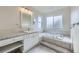 Clean white bathroom with soaker tub, step up and granite counters at 518 Zircon Way, Superior, CO 80027