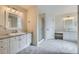 Bright Primary bathroom with double sinks, framed mirrors, and glass shower at 518 Zircon Way, Superior, CO 80027