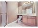 A clean bathroom featuring a shower, toilet, vanity, and large mirror, well lit with neutral tones at 518 Zircon Way, Superior, CO 80027