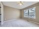 This bedroom features neutral paint, carpet, a ceiling fan, and a double window at 518 Zircon Way, Superior, CO 80027