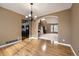 Open-concept dining room with hardwood floors and views into the kitchen and foyer at 518 Zircon Way, Superior, CO 80027