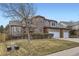 Charming two-story home with a three car garage, brick accents and a well-manicured lawn at 518 Zircon Way, Superior, CO 80027