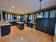 Spacious kitchen with dark cabinets, stainless steel appliances, and a large island with light countertops at 518 Zircon Way, Superior, CO 80027