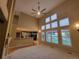 A bright living room featuring large windows, high ceilings, a ceiling fan, and view into the kitchen at 518 Zircon Way, Superior, CO 80027