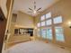 Open-concept living room with high ceilings, fireplace, and a view of the modern kitchen at 518 Zircon Way, Superior, CO 80027