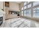Bright living room with fireplace, large windows, and an open layout to the kitchen and upstairs at 518 Zircon Way, Superior, CO 80027